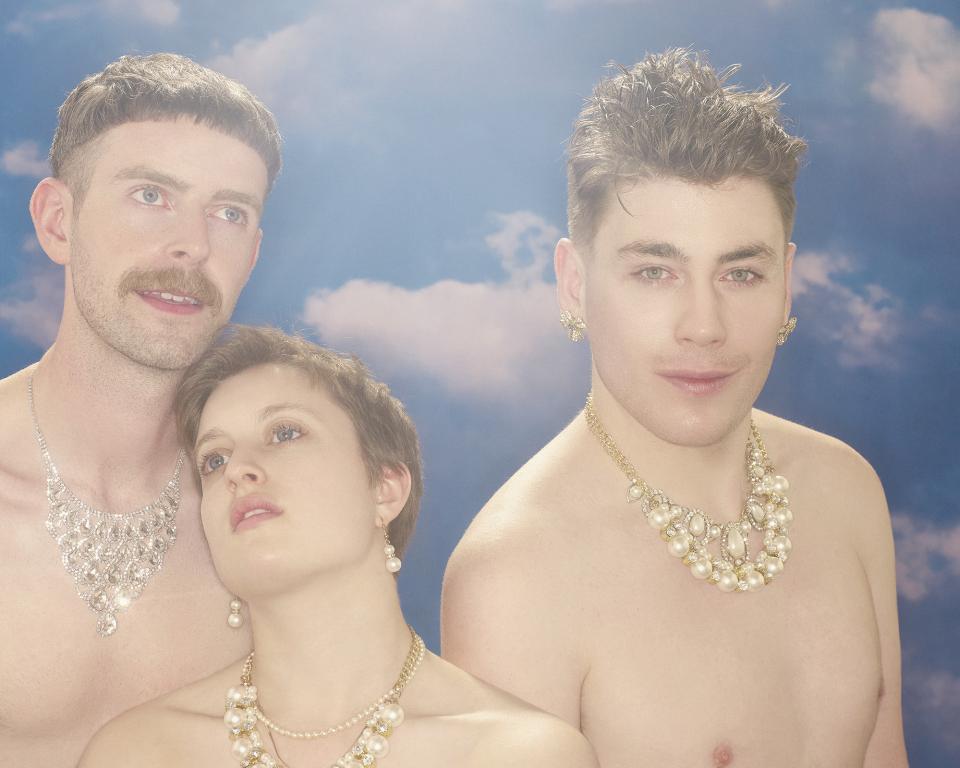 Three people standing against a heaven-like background