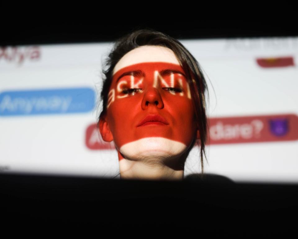 woman in front of a projected image