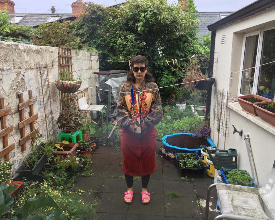 Moondog and Irene, Woman wearing red skirt in garden