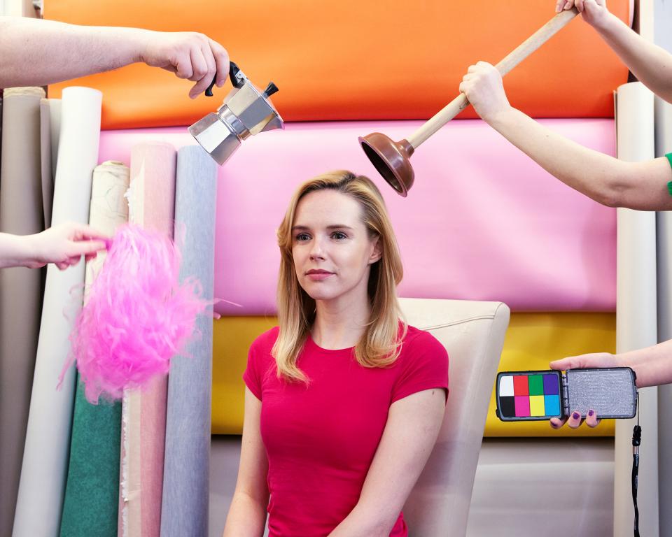 woman surrpunded by arms holding household items