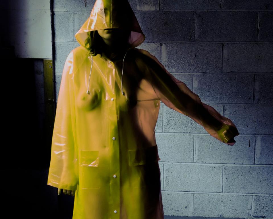 Woman in yellow hooded mac raincoat