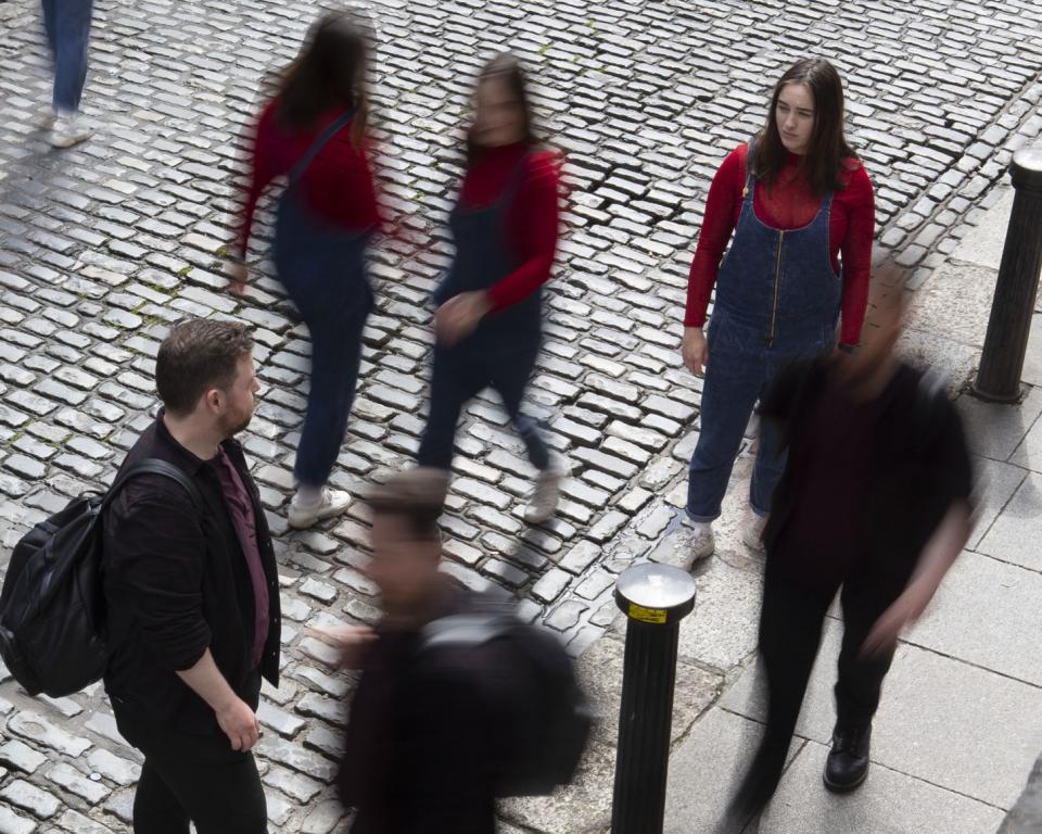 People moving about on a cobbled street