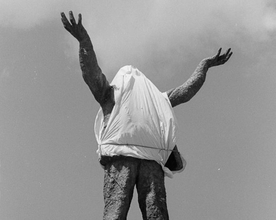 The Jim Larkin on statue on O'Connell Street with a tarpaulin tied a round
