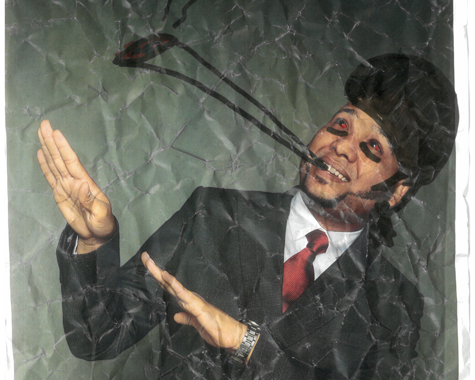 A person in a suit poses with raised hands in front of a crumpled paper-like background, with a drawn insect cigarett extending from their face.
