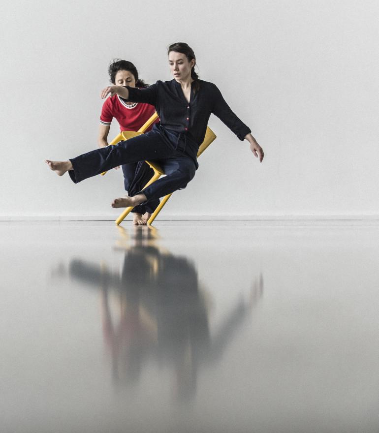INIT, two dancers one on a chair