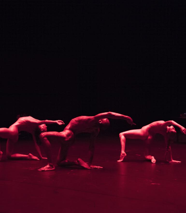 On Spirals, three dancers in red light
