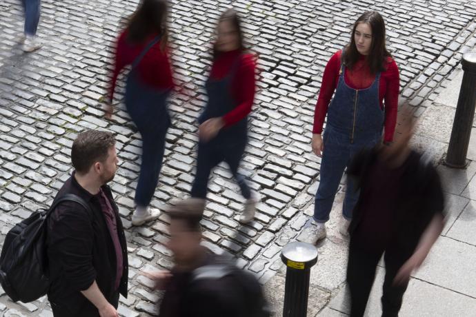 People moving about on a cobbled street