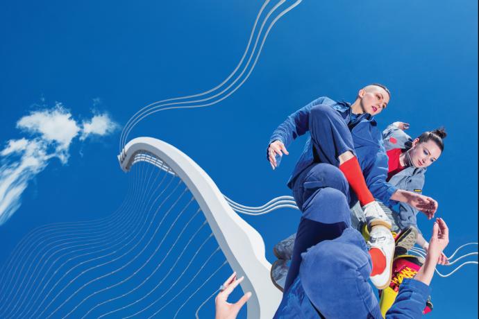 Two performers reflected against a distorted sky