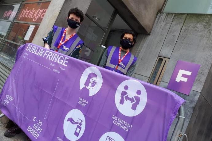 Two Dublin Fringe volunteers standing at entrance to venue