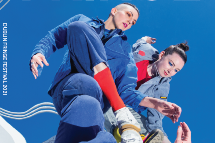 Two performers reflected against a blue sky