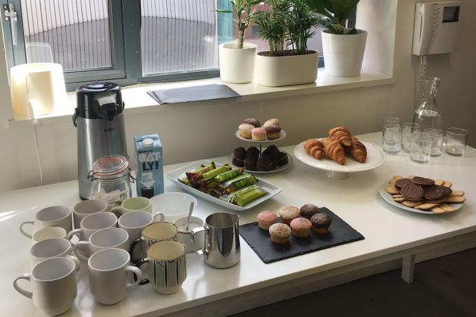 Coffee and croissants laid out on a table in front of a window