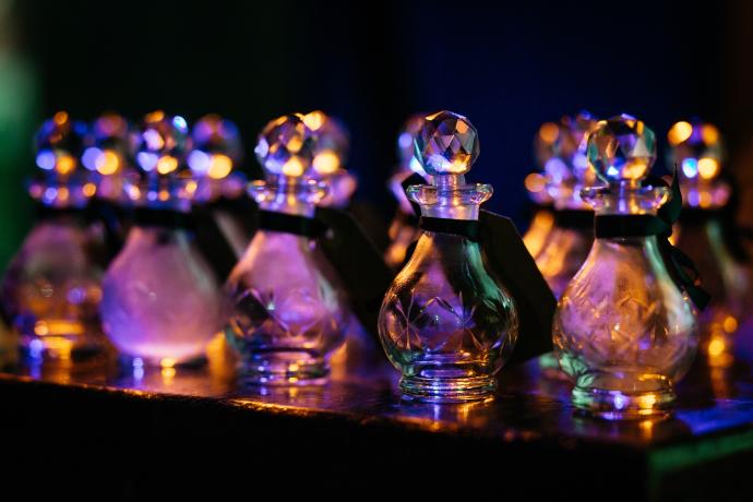 Lots of cut glass awards lined up and on a black table