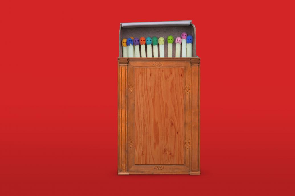 A wooden matchbox, reminiscent of a judge's bench, filled with multicoloured matches lies against a red background