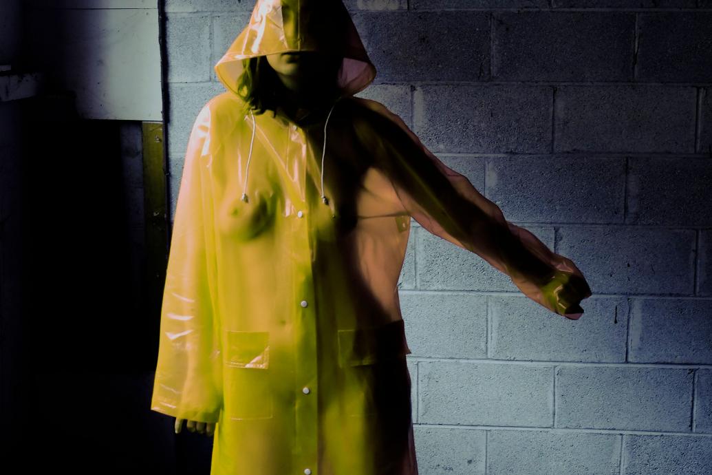 Woman in yellow hooded mac raincoat
