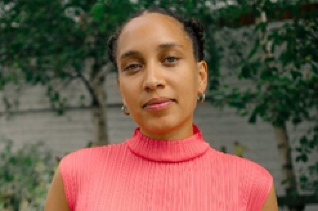 Portrait of Cairo Clarke outdoors wearing a bright pink sleeveless top