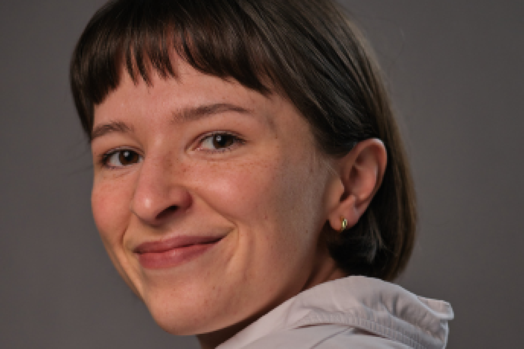 Woman in white shirt smiling at camera