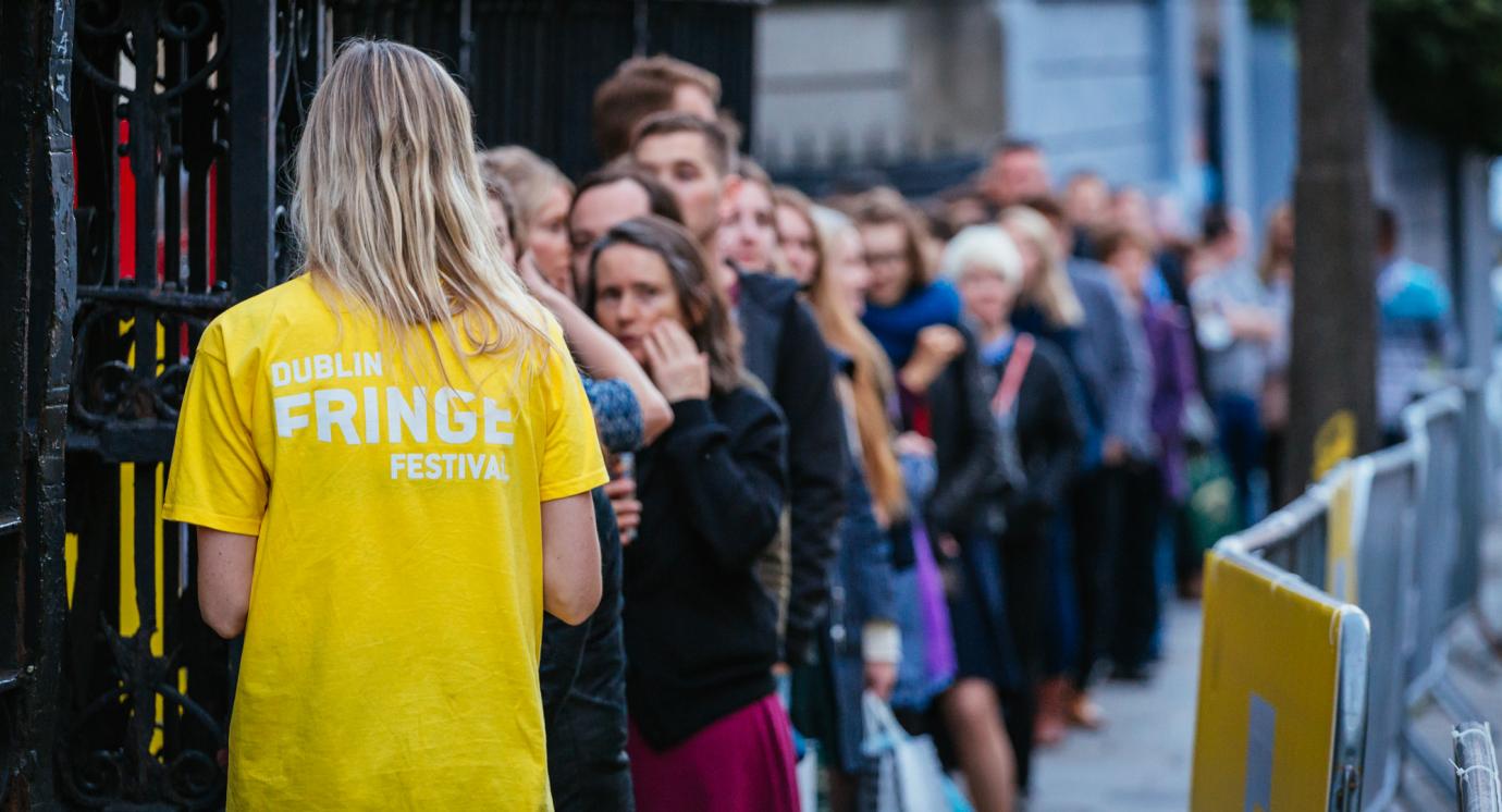 Volunteer in Dublin Fringe Festival t-shirt and crowd