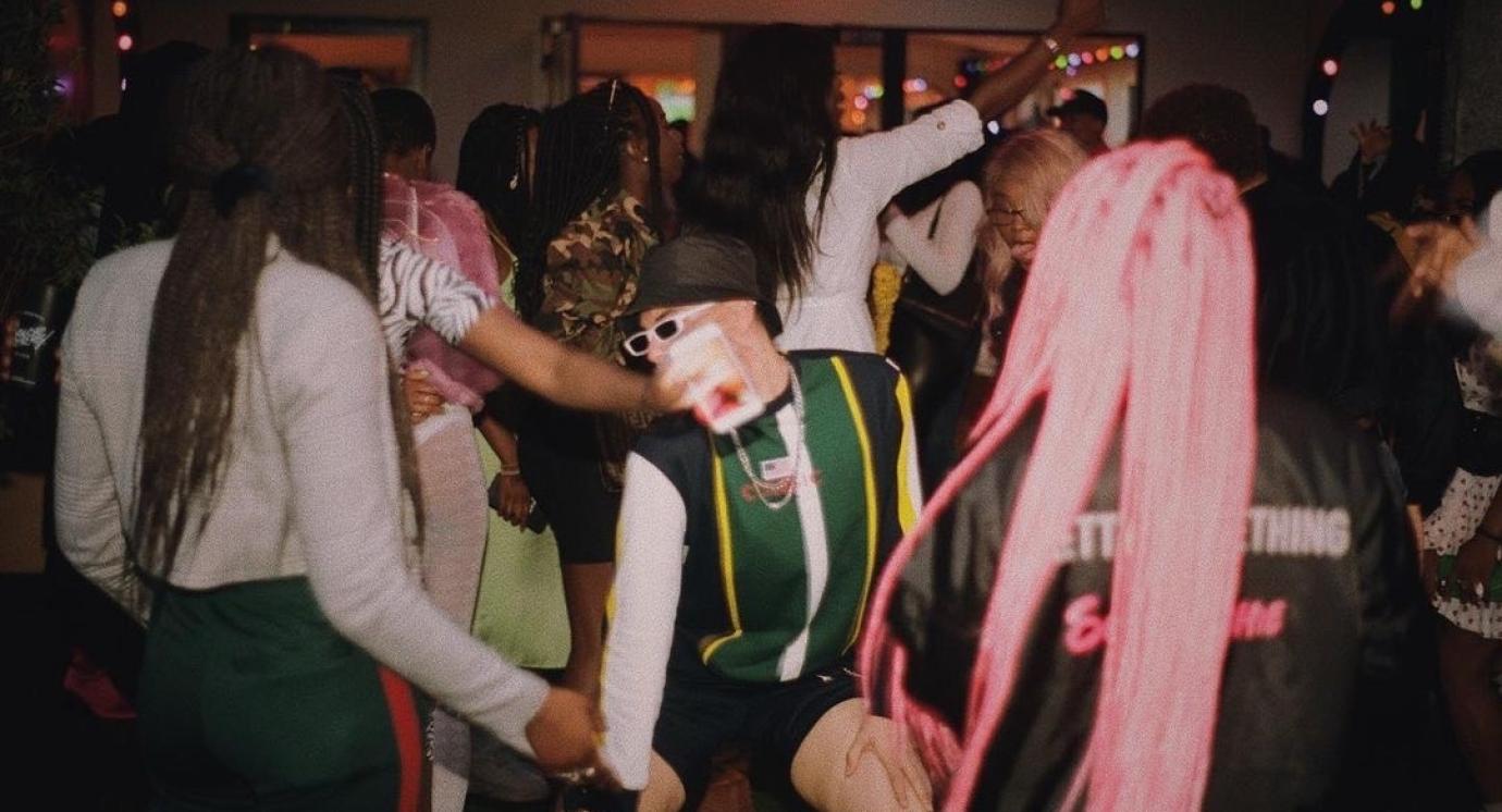 Vintage looking photo of people dancing at a club night.